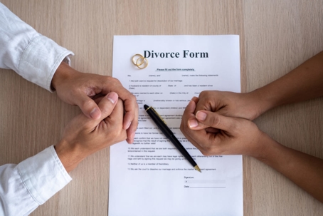 Ex-couple reviewing and signing divorce papers